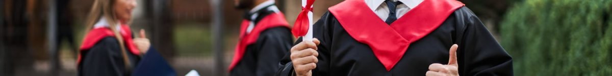 happy-caucasian-graduate-with-his-classmates-graduation-gown-holds-diploma-campus happy-caucasian-graduate-with-his-classmates-graduation-gown-holds-diploma-campus
